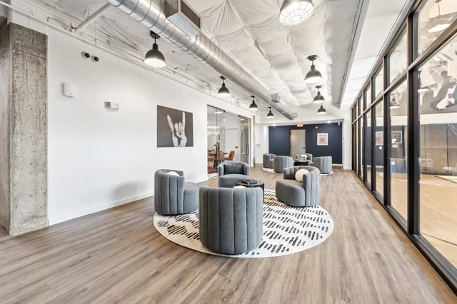 Grey seating area with artwork and gym living room at The Villas at San Gabriel in Austin Student Accommodation