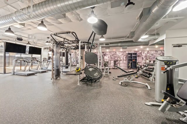 Treadmills weight machines punching bag gym area at The Villas at San Gabriel in Austin Student Accommodation
