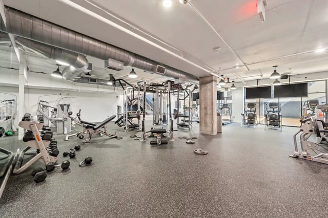 Dumbbells weight machines treadmills gym equipment gym at The Villas at San Gabriel in Austin Student Accommodation