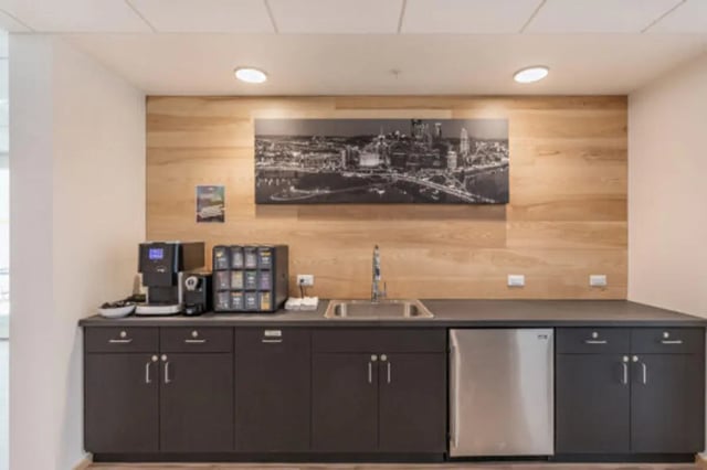 Coffee machine sink dishwasher and cabinets kitchen area at The Bridge on Forbes Apartments in Pittsburgh Student Accommodation