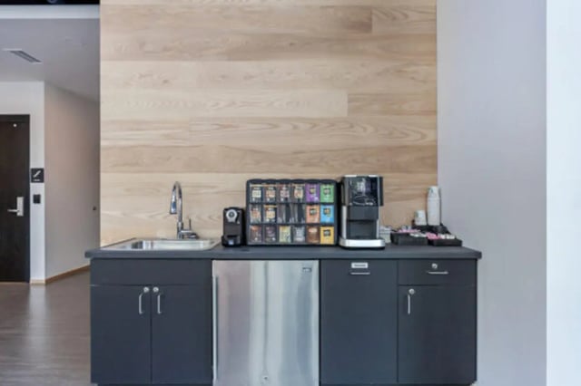 Coffee station sink refrigerator and cabinets kitchen at The Bridge on Forbes Apartments in Pittsburgh Student Accommodation