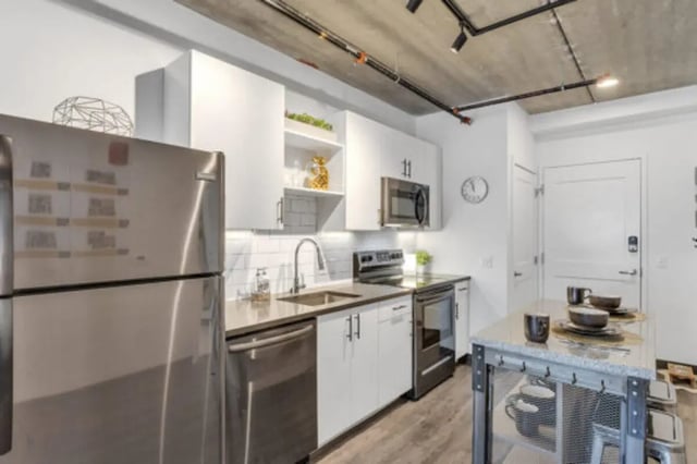 Stainless steel refrigerator white cabinets microwave kitchen. at The Bridge on Forbes Apartments in Pittsburgh Student Accommodation