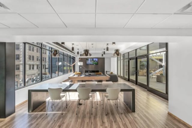 Pool table with chairs and large windows common area at The Bridge on Forbes Apartments in Pittsburgh Student Accommodation