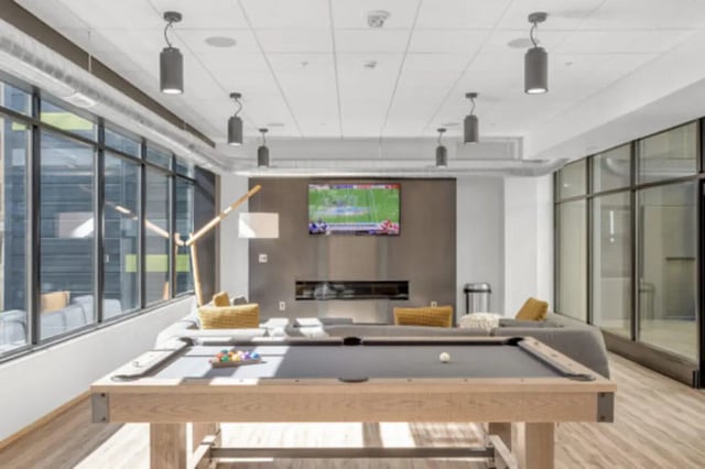 Pool table televisions fireplace and seating playing area at The Bridge on Forbes Apartments in Pittsburgh Student Accommodation