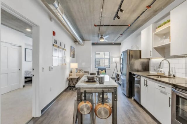 Kitchen island fridge stove cabinets sink living area kitchen at The Bridge on Forbes Apartments in Pittsburgh Student Accommodation