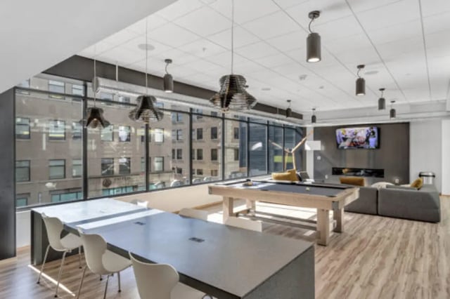 Pool table lounge area with tables and chairs at The Bridge on Forbes Apartments in Pittsburgh Student Accommodation