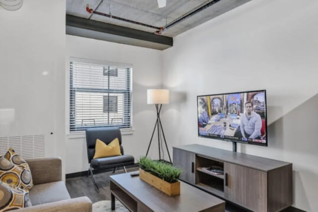 Modern living room with tv console couch and chair living room at The Bridge on Forbes Apartments in Pittsburgh Student Accommodation
