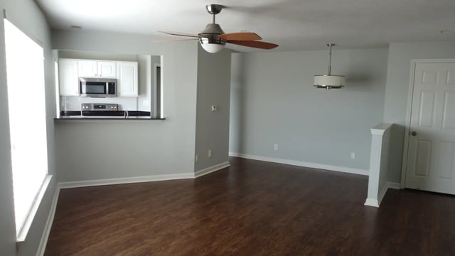 Kitchen with white cabinets microwave stove living room interior at The Landing in West Lafayette Student Accommodation