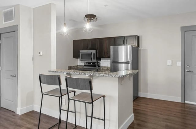 Bar stools at granite counter with appliances kitchen at 10 North in Bloomington Student Accommodation