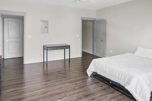 White bed dark desk two doors bedroom at 10 North in Bloomington Student Accommodation