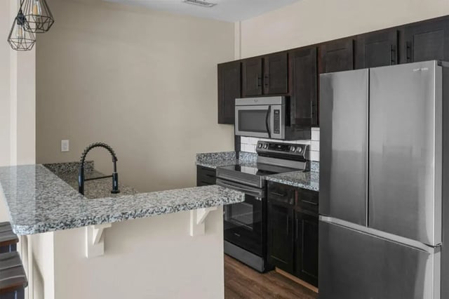 Kitchen counter sink microwave oven refrigerator kitchen at 10 North in Bloomington Student Accommodation