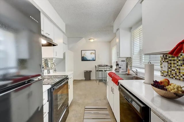 Kitchen with refrigerator oven counter and table kitchen at Across The Street Apartments in Denton Student Accommodation