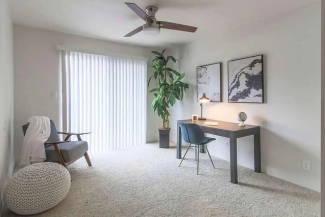 Desk chair lamp plant artwork chair pouf study area at Aero Apartments in Davis Student Accommodation