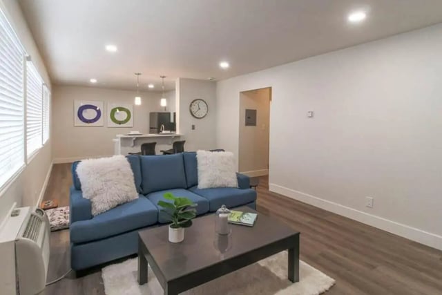 Blue sofa coffee table kitchen island living room at Aero Apartments in Davis Student Accommodation