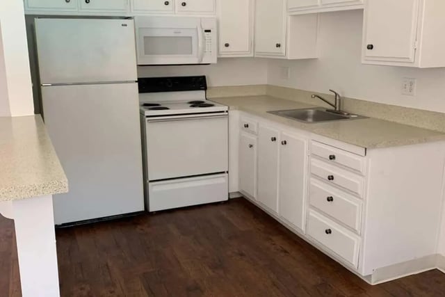 White refrigerator stove microwave sink cabinets kitchen at Aero Apartments in Davis Student Accommodation