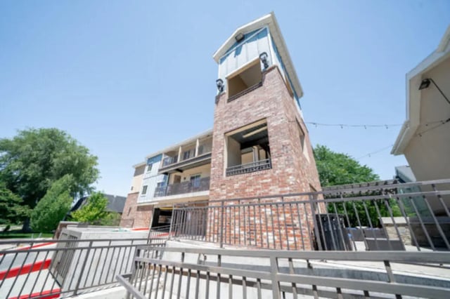 Brick and blue building with balconies exterior at CollegePlace Woodland in Provo Student Accommodation