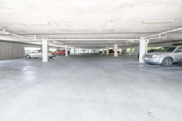 Cars parked in concrete underground garage parking exterior at CollegePlace Woodland in Provo Student Accommodation