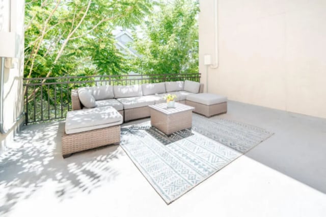 Outdoor sectional sofa with coffee table and rugs Balcony at CollegePlace Woodland in Provo Student Accommodation