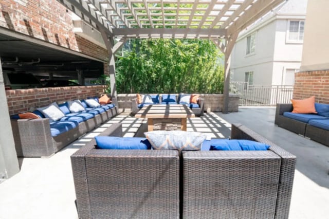 Patio with wicker furniture and blue cushions outdoor area at CollegePlace Woodland in Provo Student Accommodation