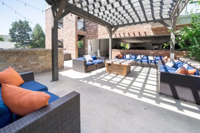 Outdoor patio seating area with pergola and fire pit patio area at CollegePlace Woodland in Provo Student Accommodation