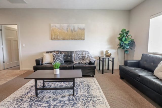 Two black couches coffee table plant living room at CollegePlace Woodland in Provo Student Accommodation