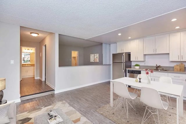 Dining area and kitchen with white cabinets living room at Ariel Court in Los Angeles Student Accommodation