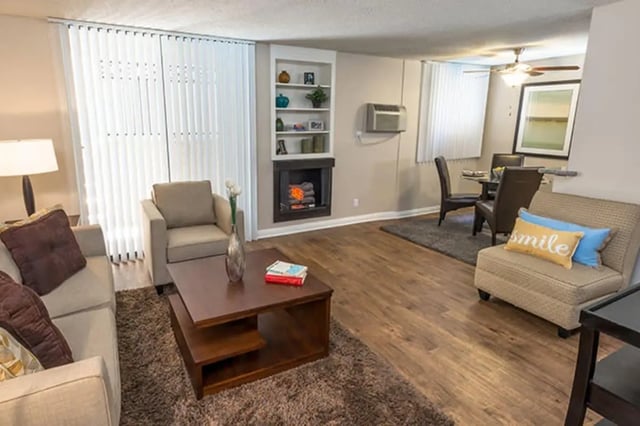 Sofa armchair fireplace dining table living room at Ariel Court in Los Angeles Student Accommodation