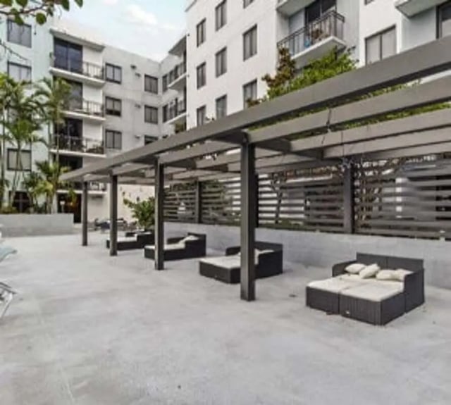 Loungers under pergola outdoor relaxation area at 4th Street Commons Apartments in Miami Student Accommodation
