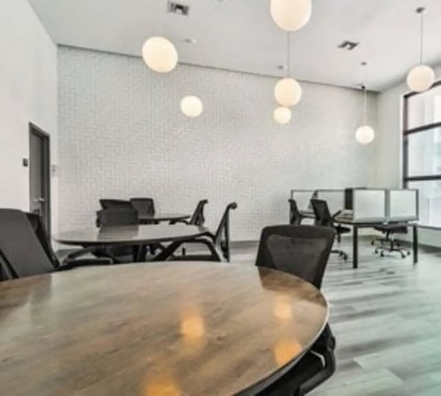 Round tables chairs and study cubicles common area at 4th Street Commons Apartments in Miami Student Accommodation