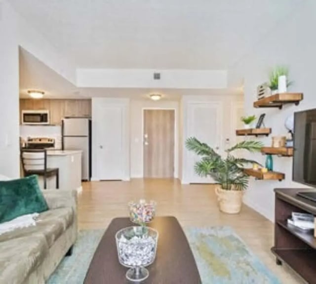 Sofa kitchen open shelves living room at 4th Street Commons Apartments in Miami Student Accommodation