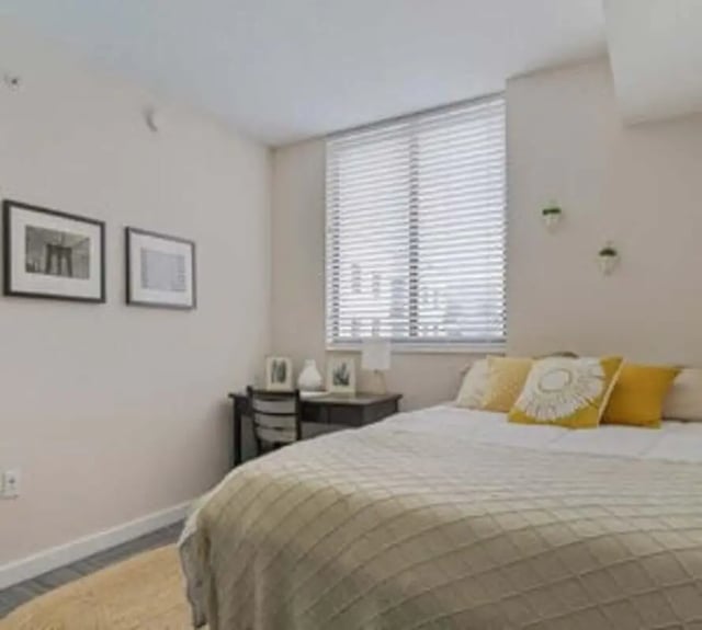 Bed with yellow pillows desk pictures window bedroom at 4th Street Commons Apartments in Miami Student Accommodation