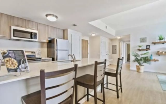 Kitchen island with stools and countertop appliances kitchen at 4th Street Commons Apartments in Miami Student Accommodation