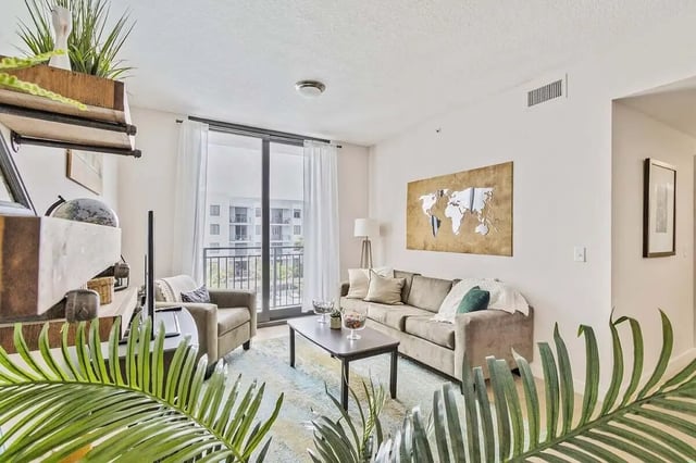 Sofa armchair coffee table world map living room at 4th Street Commons Apartments in Miami Student Accommodation