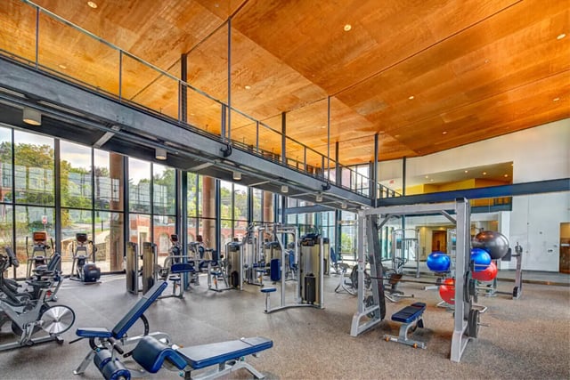Gym equipment with large windows and mezzanine gym at Collegetown Terrace Apartments in Ithaca Student Accommodation