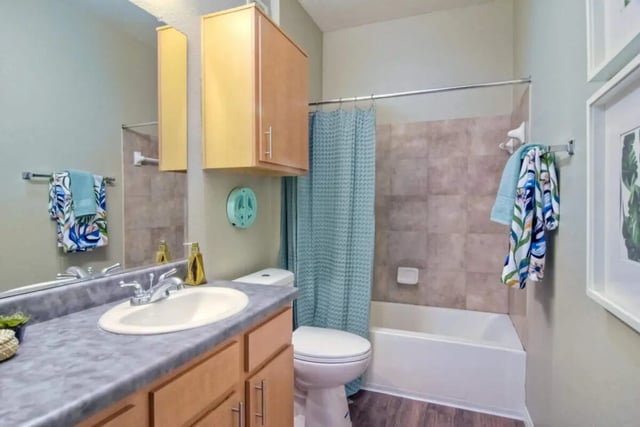 Sink toilet bathtub cabinets towels shower curtain Bathroom at 5025 apartments in San Diego Student Accommodation