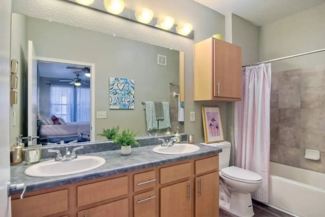 Double sink vanity toilet shower and bathtub bathroom at 5025 apartments in San Diego Student Accommodation