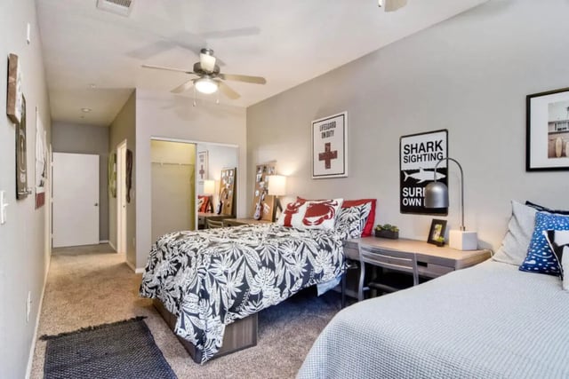 Two beds and desks in bedroom at 5025 apartments in San Diego Student Accommodation