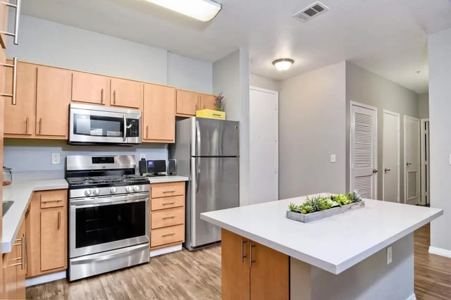 Kitchen with stainless steel appliances island kitchen at 5025 apartments in San Diego Student Accommodation