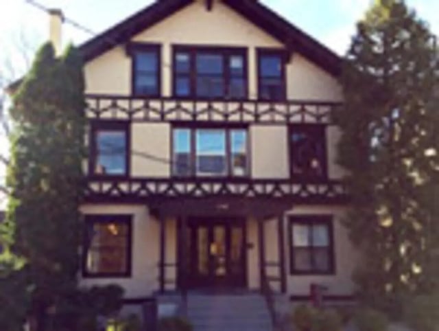 Tudor style house with windows and trees exterior at Ashley Management Corporation in Ithaca Student Accommodation
