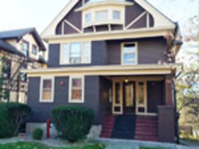 Dark house with porch and entrance exterior at Ashley Management Corporation in Ithaca Student Accommodation