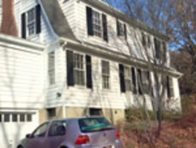 White house with garage and car exterior at Ashley Management Corporation in Ithaca Student Accommodation