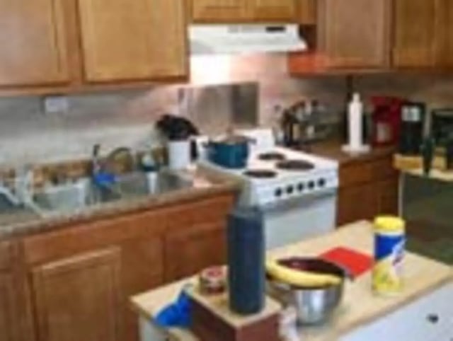 Wooden cabinets stove sink and countertop kitchen at Ashley Management Corporation in Ithaca Student Accommodation