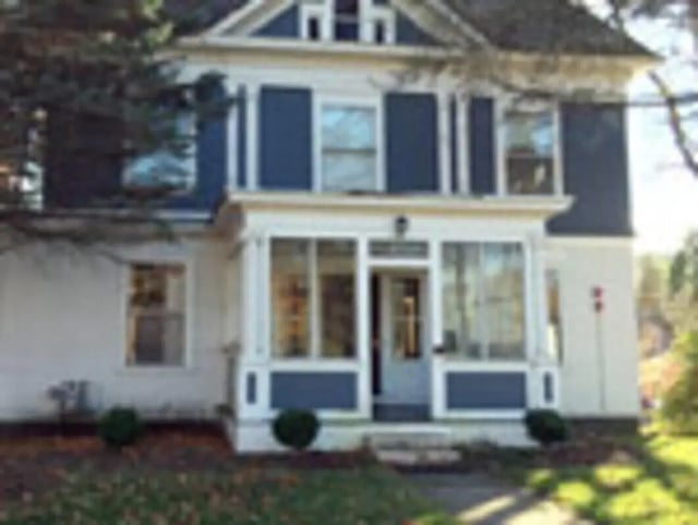 Large white house blue shutters large windows exterior at Ashley Management Corporation in Ithaca Student Accommodation