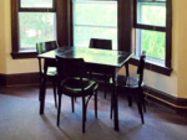 Dining table and chairs by window dining area at Ashley Management Corporation in Ithaca Student Accommodation