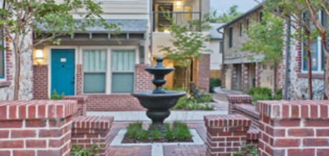 Fountain with brick buildings exterior at Ashton Lane Luxury Apartments in Gainesville Student Accommodation