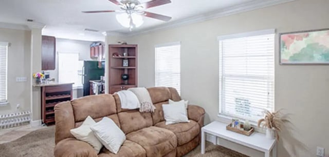 Brown sofa pillows ceiling fan kitchen cabinets living room at Ashton Lane Luxury Apartments in Gainesville Student Accommodation