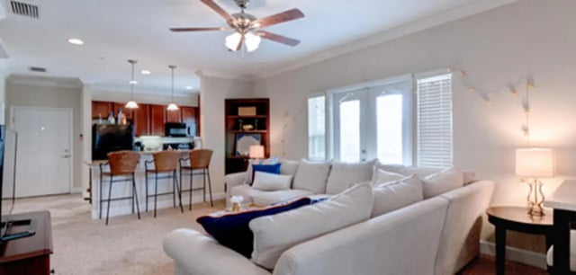 Sofa bar stools and kitchen island living room at Ashton Lane Luxury Apartments in Gainesville Student Accommodation