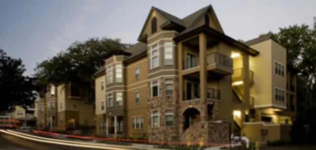 Multi-story building with balconies and stone accents exterior at Ashton Lane Luxury Apartments in Gainesville Student Accommodation
