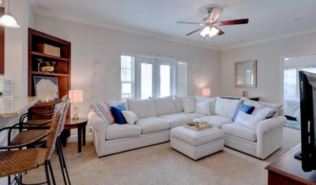 Large sectional sofa bar stools bookshelf living room at Ashton Lane Luxury Apartments in Gainesville Student Accommodation