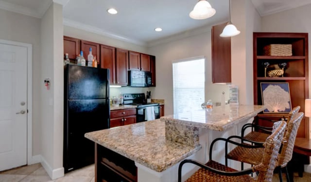 Kitchen with black refrigerator and bar stools kitchen at Ashton Lane Luxury Apartments in Gainesville Student Accommodation